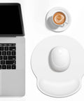Ergonomic Mouse Pad With Memory Foam Wrist Rest For Pain Relief And Fatigue Reduction Ultra Smooth Surface And Non Slip Base Go To Choice For Gaming Office And Laptop Use White next to laptop and coffee cup.