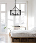 Luton Cage Metal Chandelier with Clear Cylinder Glass Shades Six Light Uplights in bedroom setting.
