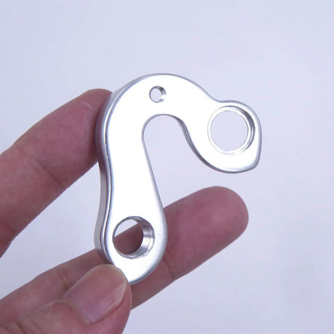 Person holding Derailleur Hanger 240 Drop In Replacement For Felt AR5 Z100 2011 2016 Z5 F1X F15X Cyclo X Canti Brake Pre 2018 CNC Machined Aluminum Alloy Rear Mech Dropout
