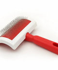 Curved Slicker Brush For Fur And Sheepskin Rugs Pet Grooming Tool With Stainless Steel Pins, red handle on white background