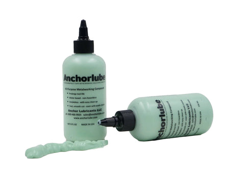 Two Anchorlube all-purpose metalworking compound bottles, 8 oz, water-based cutting fluid; mint-green gel spill, front.