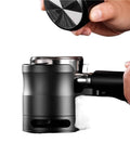 Boss Level 58Mm Espresso Tamping Station With Slick Anti Slip Base And Quick Adjustable Frame For Hassle Free Coffee Tamping Plus Nifty Grounds Catch Tray in use during coffee preparation.