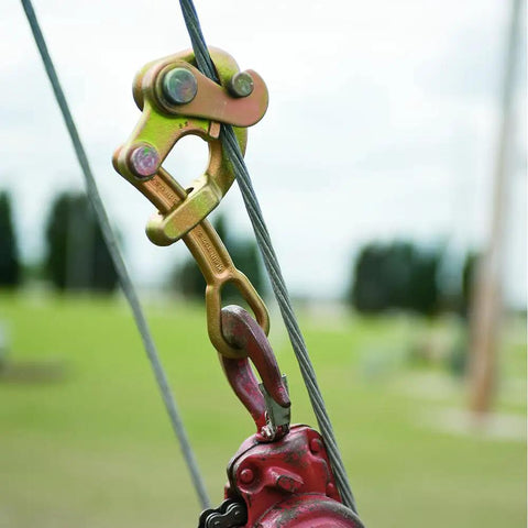 Haven's Grip Wire Pulling Tool For Wire Rope Up To 0.75 Inch, attached to red machinery in outdoor field