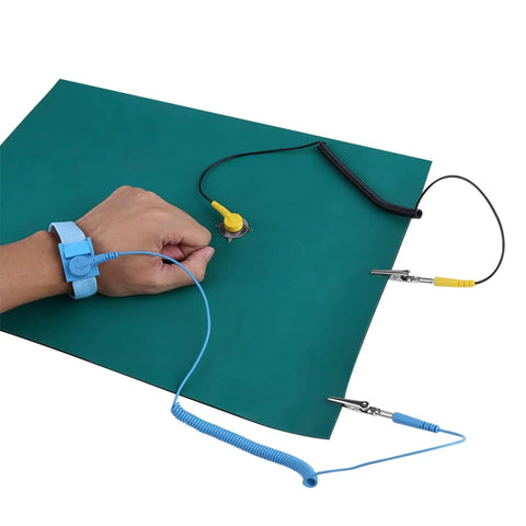 Pro Grade Anti Static Work Mat With Wrist Strap And Grounding Cord For Electronics Repair And PC Building 11 8 By 15 7 Inches ESD Safe Bench Pad With Surface Resistivity 106 To 109 Ohms For Peak Static Protection, showing mat and wrist strap in use.