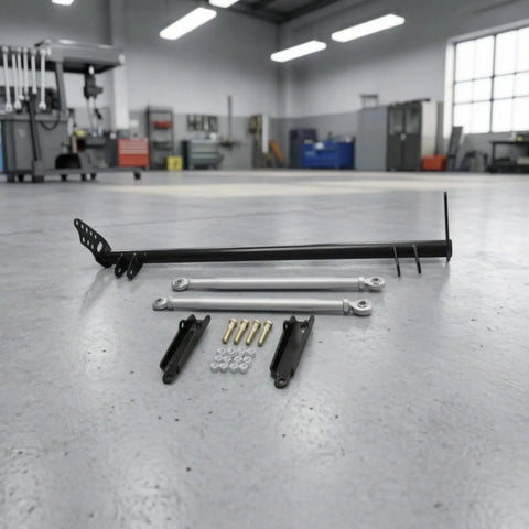 Heavy Duty Rear Traction Control Rod Assembly And Chassis Brace Kit Featuring Carbon Steel Build To Kill Wheel Hop While Beefing Up Sedan Rigidity For Strong Launches And Tight Cornering With 1992 Through 1995 Fitment components on floor.