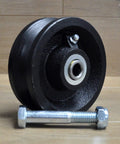 4-inch black cast-iron V-groove gate caster wheel with bearing bore and mounting bolt (front view)