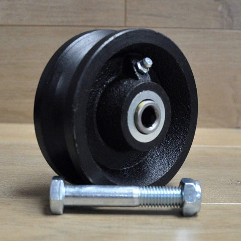 4-inch black cast-iron V-groove gate caster wheel with bearing bore and mounting bolt (front view)