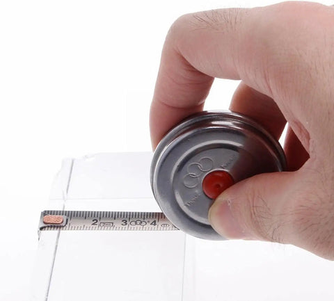 Heavy Duty Retractable Tape Measure With Self Locking Belt Loop Clip And Strong Magnetic Hook For Fast Woodworking Construction On Professional Job Sites And Home Outdoor Renovations, held by hand measuring a clear object.