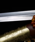 Close-up of Flexible Tai Chi Sword Hand Forged Damascus Folded Steel Chinese Jian with gold floral detailing and sandalwood scabbard