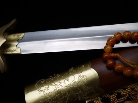 Close-up of Flexible Tai Chi Sword Hand Forged Damascus Folded Steel Chinese Jian with gold floral detailing and sandalwood scabbard