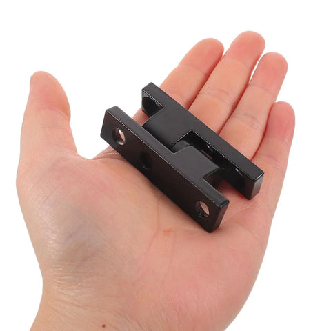 Person holding black zinc alloy detachable door barrel hinges for cabinets and cupboards, heavy duty with integrated lock and mounting holes.