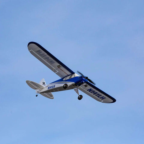 Blue and white Sport Cub S 2 RC Airplane BNF Basic with Safe Technology Ideal Trainer for Beginners and Pros flying mid-air