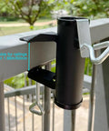 Beefy Heavy Duty Patio Umbrella Clamp Holder For Fences And Decks on railing, showing black steel with 1.96-inch opening.