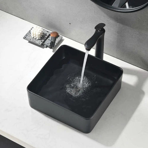 Sleek Matte Black Rectangle Vessel Sink 14 By 14 Inch Above Counter Vanity With Porcelain Ceramic Low Water Absorption Acid Resistant Easy To Clean Surface Durable Modern Bathroom Vessel Sink With Black Pop Up Drain.