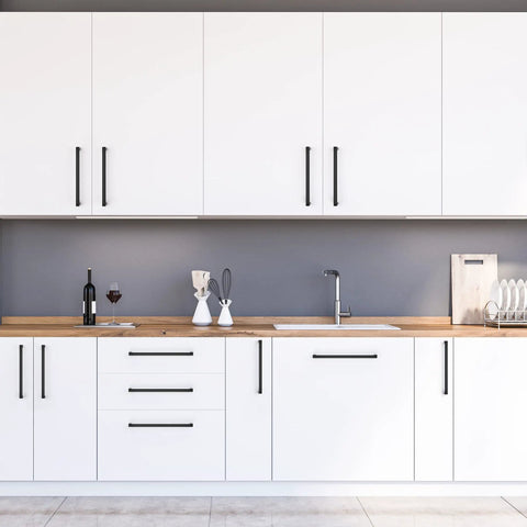 White kitchen cabinets with Matte Black Square Cabinet Handles Set for Kitchen Drawers, showing their sleek style.