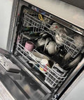 Interior view of Heavy Duty Full Size Drawer Dishwasher for Bustling Kitchens full of dishes and glassware ready for quick wash cycle.