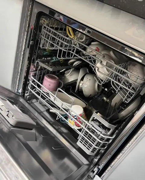Interior view of a loaded Slick Full Size Drawer Dishwasher For Home With Concealed Touch Controls And Hella Quiet Wash Cycle.