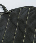 Close-up of X Pad Suppressor Handler in black with DuPont Kevlar stitching, CarbonX heat resistance up to 2000°F for tactical duty gear.