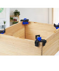 90 Degree Angle Clamps Set Of 4 For Woodworking shown on wooden corner with blue clamps