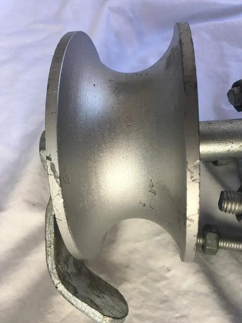 Close-up of gray metal rear pipe track wheel for chain link sliding gates, showing rugged design and screws, heavy duty hardware.
