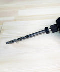 One Quarter Inch Hex Shank Pocket Hole Drill Bit With Depth Stop Collar installed in a drill for woodworking on a board