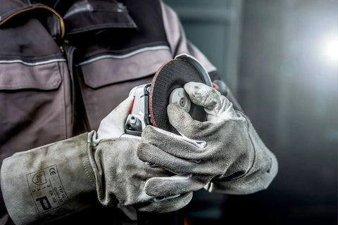 Worker adjusting Beefy Four And A Half To Five Inch Angle Grinder With Eleven Thousand RPM And Twelve Amp Power AC DC Versatility