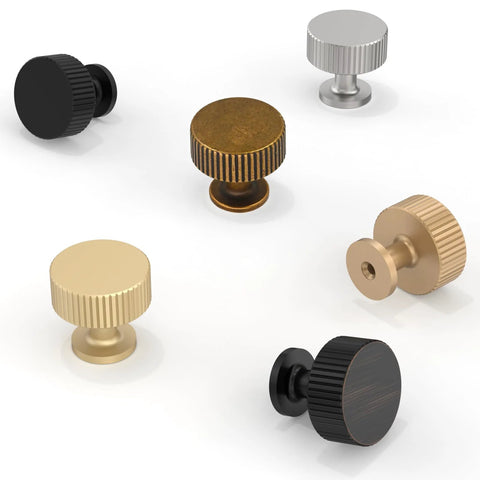 Assorted round cabinet knobs in various finishes including antique brass, showcasing the design and variety available.