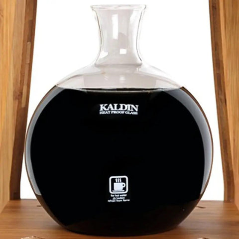 Kick Back And Sip Smooth Cold Brew With This Sleek Dutch Coffee Maker And Glass Tower Designed For Fifteen Friends Featuring Bamboo Frame And No Fuss Drip System For Fresh Iced Sips Anytime. Black glass coffee server on bamboo stand.