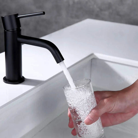Dope Matte Black One Hole Bathroom Faucet With Pop Up Drain And Supply Hose, Single Handle Lavatory Faucet in use with water filling a glass