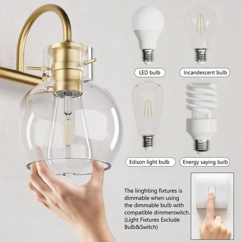 Hand adjusting globe shade on Two-Light Gold Bathroom Vanity Light Fixture With Clear Globe Shades, E26 base options shown