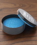 Open container of blue watch gasket grease, part of the Two Pack Watch Gasket Grease Silicone Sealant For Wristwatches O Ring Maintenance And Repair Tool Set For DIYers Watchmakers And Professionals Black Lubricant For Leak Free Seals.