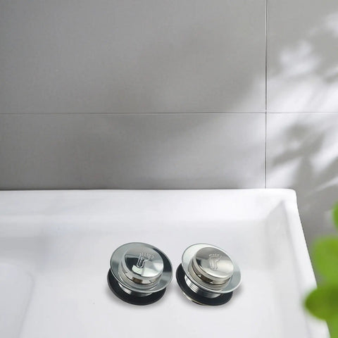 Bathroom Silver Pop-Up Bathtub Waste Drain-Plug, Alloy and Brass Floor Drain for Tub, Water-Tight Seal Push Button Mechanism(2pcs) on white tub surface.
