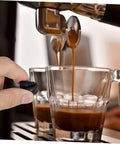 Two Pack Espresso Steam Wand Rubber Sleeve Covers for heat safety, black rubber guard being used by hand next to coffee cups