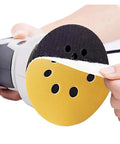User placing a 125mm Yellow Sanding Disc on a power tool, showcasing the bulk pack of 50 premium sanding discs.