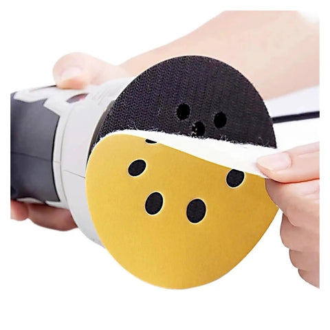 User placing a 125mm Yellow Sanding Disc on a power tool, showcasing the bulk pack of 50 premium sanding discs.