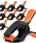 Eight HORUSDY 5-inch plastic spring clamps with orange handles and black bodies, 2-3/8 in jaw opening