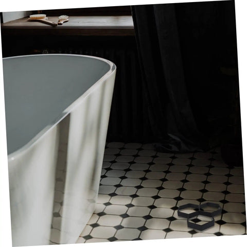 Bathroom with white freestanding bathtub and black-and-white tiled floor, displaying a DIY Hexagon Cement Floor Mold For Garden Paths And Patios.