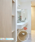 Bathroom setting with Zigbee Water Leak Sensor With Dripping Detection, 120dB Alarm, App Alerts near sink on tiled floor.