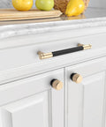 Image of 10 Pack Matte Black And Gold Knurled Cabinet Knobs installed on white kitchen cabinets, featuring zinc drawer knobs with durable hardware.