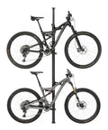 Vertical Tension Floor To Ceiling Bicycle Storage Column For Two Bikes Black Aluminum Hanger Adjustable From 2.1m To 10m Space Saving Slick Modern Design For Home Garage Or Studio shown with two bikes mounted side by side, made of black aluminum with a sleek finish.