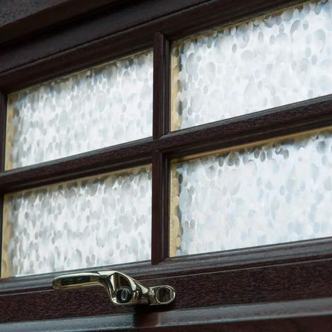 Image showing the Self-Adhesive Privacy Window Film, 17 Inches By 78 Inches, Pearl, 2 Pack with Applicator on window panel.