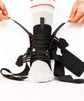 Person slipping on Dope Quick Lace Ankle Brace 2.0 For All Sports Enthusiasts, focusing on unisex quick lace support.