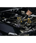 Mechanic using Xtreme 12V Max Brushless One Half Inch Cordless Impact Wrench Tool Only in engine bay of a vehicle