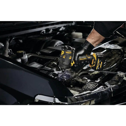 Mechanic using Xtreme 12V Max Brushless One Half Inch Cordless Impact Wrench Tool Only in engine bay of a vehicle