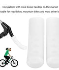 Pair of white silicone brake lever covers for road and mountain bikes shown with a brake lever.