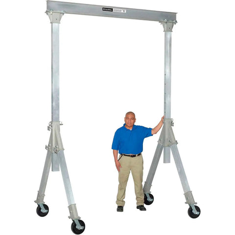 Portable Adjustable Height Aluminum Gantry Crane Lightweight Workshop Hoist With No Fuss Setup Easy Lift Gear Without Breakin Sweat For Tight Garage Bays next to a man, showing height and sturdy base.
