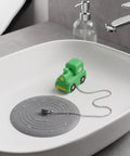 TEHAUX Silicone Bathtub Drain Stopper 15cm, Hair Catcher for Bathroom with playful green toy car in sink.