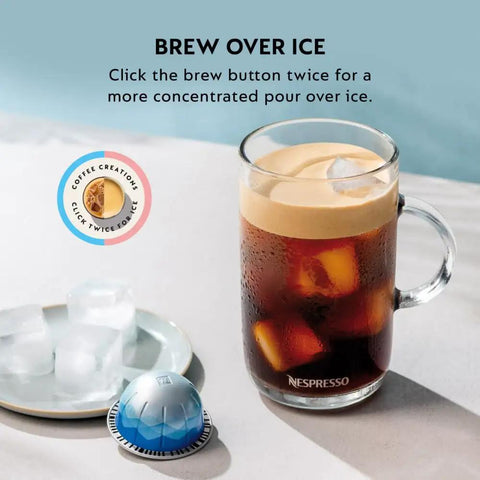 Glass of iced coffee next to a coffee capsule and ice tray, brewed using Vertuo Pop Plus Coffee And Espresso Machine With Five Cup Sizes.