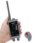 Hand holding Premium Hidden Devices Detector Kit Your Go To Tool For Spotting Hidden Cameras RF Signals GPS Tracking And Spy Bugs Anti Spy Sweeper That Finds Wireless Transmitters Camera Lenses And Hidden Bugs Fast beside a small receiver
