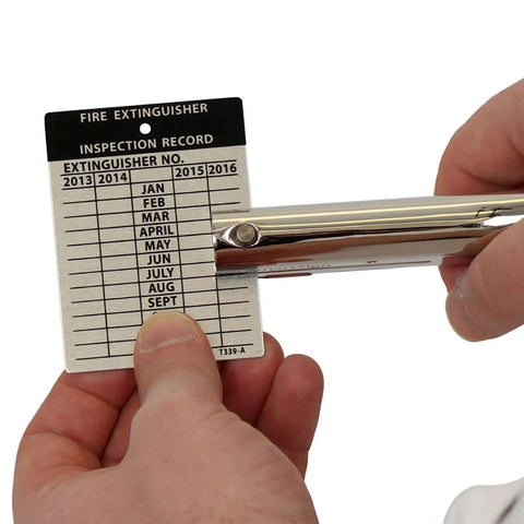 Heavy Duty Handheld Workhorse Single Hole Punch With 1/8 Inch Punch And 2 Inch Reach in use on inspection record card